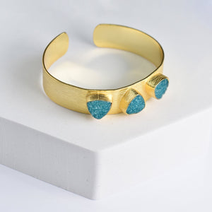 Triangle Druzy Bracelet with turquoise accents on a white display by Vanya Lara.