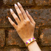 Load image into Gallery viewer, A person&#39;s hand with painted nails and a Triangle Druzy bracelet by Vanya Lara against a brick wall.
