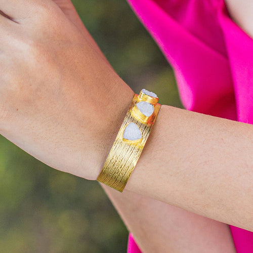 A Triangle Druzy bracelet with heart-shaped Druzy gemstones from Vanya Lara on a person's wrist.