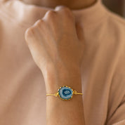 A person wearing a Vanya Lara Sliced Quartz Bracelet with a solar quartz centerpiece.