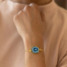 Load image into Gallery viewer, A person wearing a Vanya Lara Sliced Quartz Bracelet with a solar quartz centerpiece.
