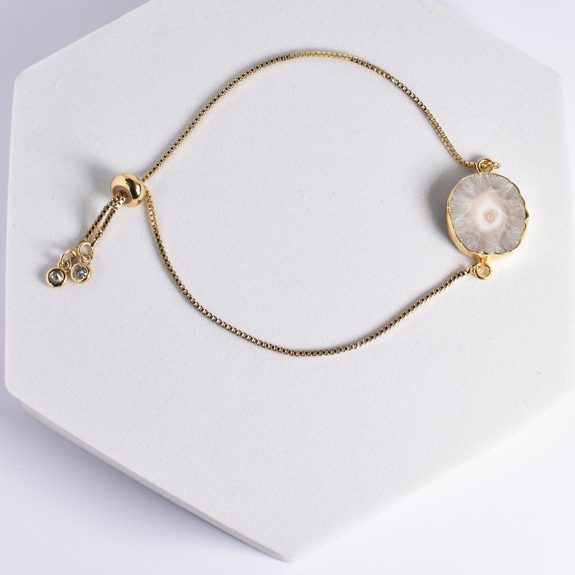 Sliced Quartz Bracelet - VBR0004 by Vanya Lara with a round pearl pendant and decorative elements on a white display stand.