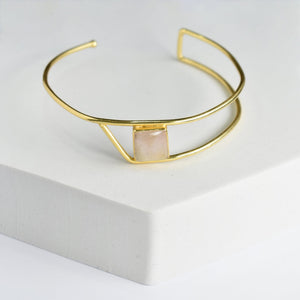 Golden Ratio Bracelet by Vanya Lara with a square pink natural gemstone on a white surface.