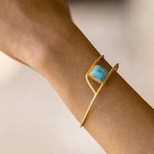 Load image into Gallery viewer, A Golden Ratio Bracelet - VBR0006 by Vanya Lara with a blue gemstone, worn on the wrist with free shipping.
