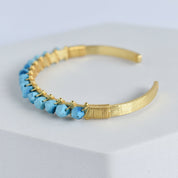 Trillion Cut Gemstone Bangle with blue gemstone embellishments by Vanya Lara.