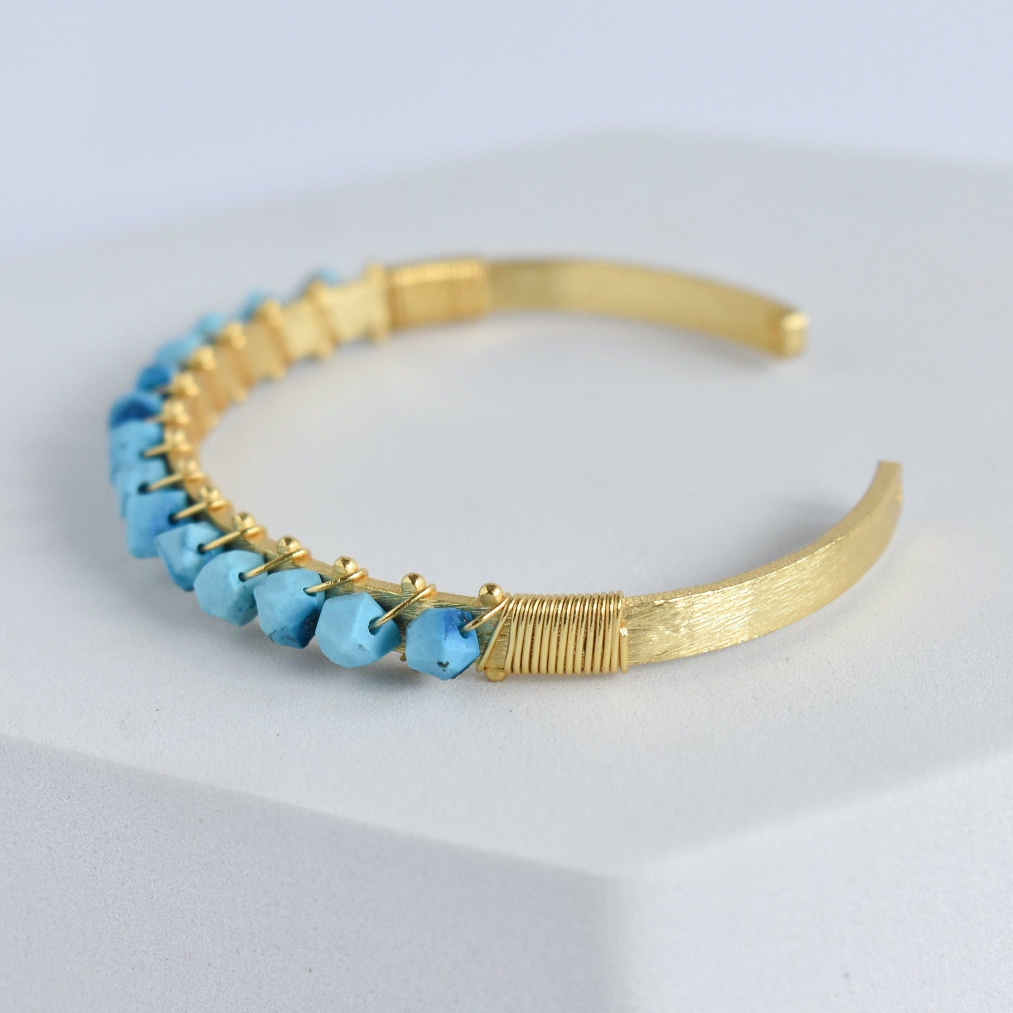 Trillion Cut Gemstone Bangle with blue gemstone embellishments by Vanya Lara.