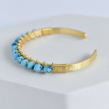 Load image into Gallery viewer, Trillion Cut Gemstone Bangle with blue gemstone embellishments by Vanya Lara.
