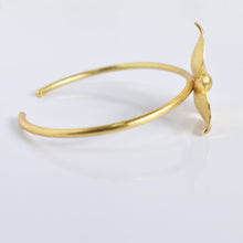 Load image into Gallery viewer, Golden Flower Bracelet by Vanya Lara, showcasing exquisite craftsmanship with a single floral embellishment, ideal for party wear, on a white background.
