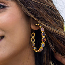 Load image into Gallery viewer, Close-up of a woman wearing an elegant Vanya Lara Kaleidoscope Hoop Earrings VER0002 studded with colorful Hydro-stone gemstones.
