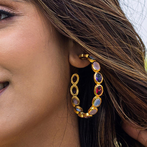 Close-up of a woman wearing an elegant Vanya Lara Kaleidoscope Hoop Earrings VER0002 studded with colorful Hydro-stone gemstones.