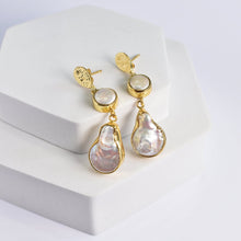 Load image into Gallery viewer, A pair of Vanya Lara&#39;s Pearl of Joy Earrings - VER0004 displayed on a white stand.

