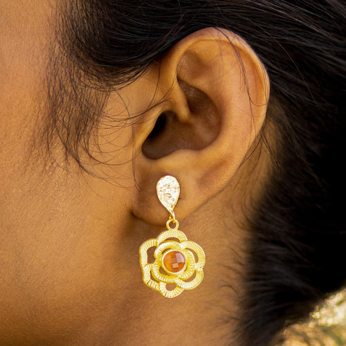 A woman wearing Vanya Lara's Floral Drop Earrings (VER0007) with intricate designs.