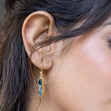 Load image into Gallery viewer, A close-up of a woman&#39;s ear wearing a dangling earring with a Mojave turquoise stone: Mojave Brick Earrings by Vanya Lara - VER0008.
