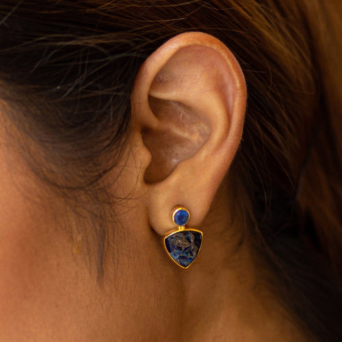 Close-up of a woman's ear wearing Vanya Lara's Triangle Drop Earrings (VER0009) with gold plating.
