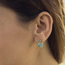 Load image into Gallery viewer, Close-up of a woman&#39;s ear wearing a Vanya Lara turquoise triangle drop stud earring (VER0009).
