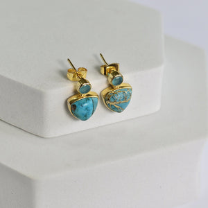 Triangle Drop Earrings - VER0009 by Vanya Lara with turquoise stones displayed on a white stand.