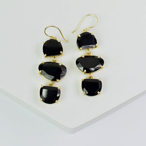 Pair of Long Triple Drop Earrings - VER0011 with natural black gemstones on a white surface by Vanya Lara.