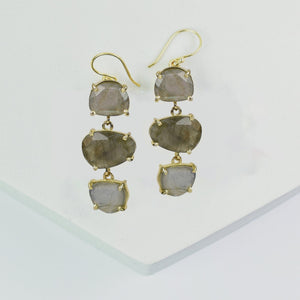 A pair of Vanya Lara Long Triple Drop Earrings with faceted grey natural stones on a white background.