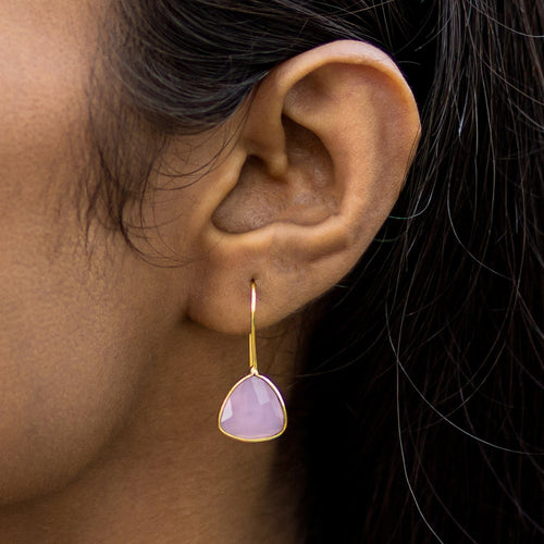 A close-up of a woman's ear wearing a Vanya Lara Beyond The Dainty Earrings - VER0014 earring with a pink hydro stone stud.