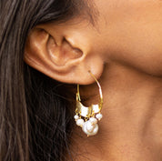 Crescent Moon Hoops Earrings by Vanya Lara, worn on a person's ear.