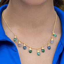 Load image into Gallery viewer, A Kaleidoscope Drop Necklace - VNK0002 by Vanya Lara with multiple teardrop-shaped hydro stones pendants displayed on a person wearing a blue top.
