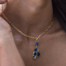 Load image into Gallery viewer, A close-up of a person wearing a Vanya Lara Mojave Drop Necklace - VNK0003 with a turquoise stone pendant.
