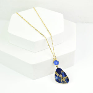 Mojave Drop Necklace by Vanya Lara with a blue Mojave turquoise stone pendant on a white display stand.