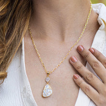 Load image into Gallery viewer, A woman wearing a Mojave Drop Necklace by Vanya Lara with a turquoise stone pendant, complemented by a manicure in a matching color.
