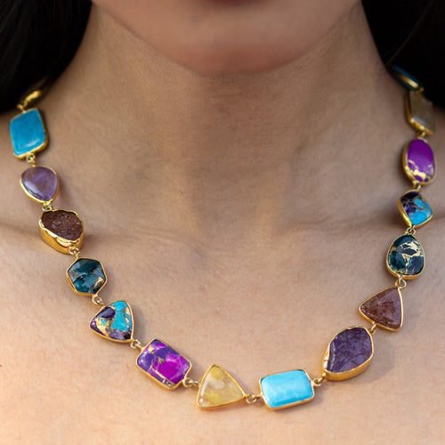 Close-up of an Enchanting Melody Necklace by Vanya Lara around a person's neck.