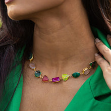 Load image into Gallery viewer, A woman showcasing an Enchanting Melody Necklace by Vanya Lara against a green blouse.
