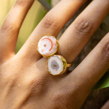Load image into Gallery viewer, A hand adorned with two gold rings from the Vanya Lara Solar Quartz Ring collection, featuring polished, round, and banded solar quartz stones.
