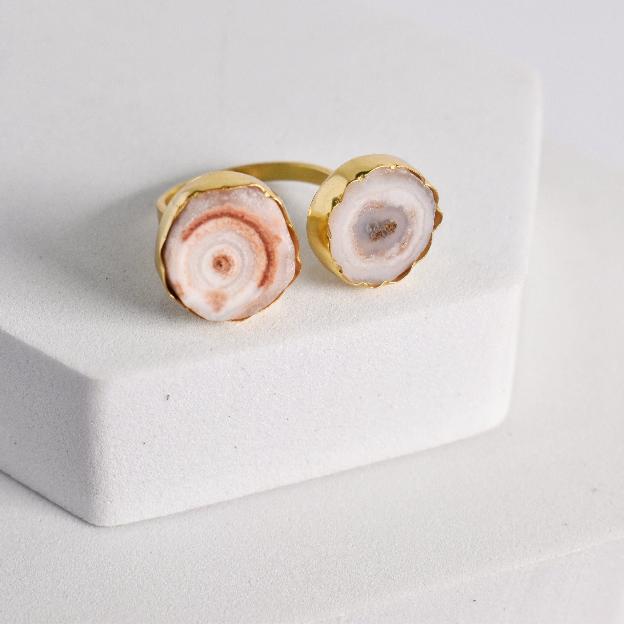 Vanya Lara's Solar Quartz Ring - VRG0001 with dual solar quartz stone inlays displayed on a white block.