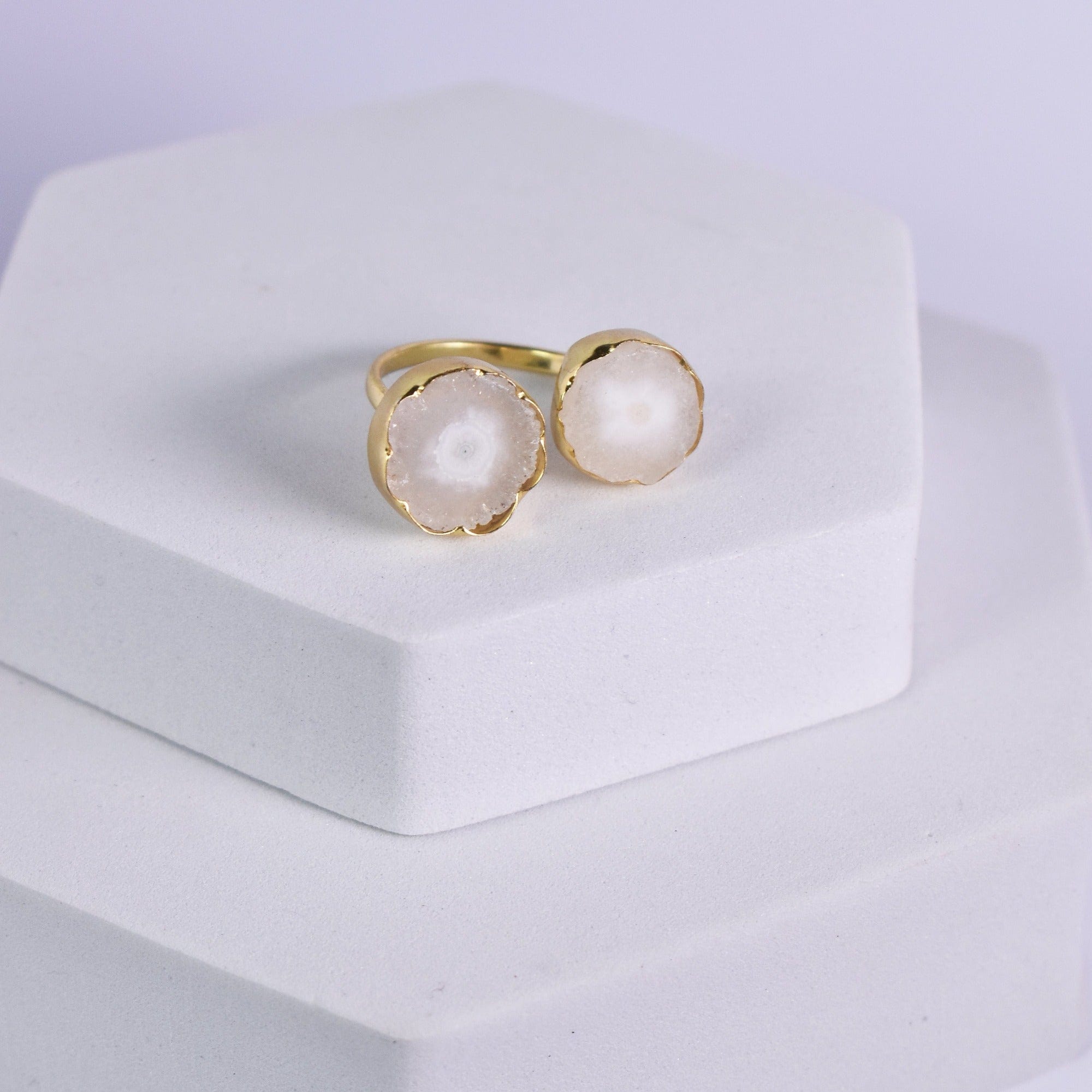 A pair of Vanya Lara Solar Quartz Rings (VRG0001) displayed on a white pedestal.