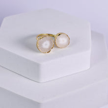Load image into Gallery viewer, A pair of Vanya Lara Solar Quartz Rings (VRG0001) displayed on a white pedestal.
