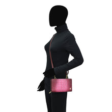 Load image into Gallery viewer, A silhouette of a person carrying a pink Anuschka Organizer Wallet Crossbody - 1149 against a white background.
