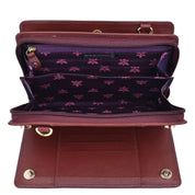 An open brown genuine leather Organizer Wallet Crossbody - 1149 with multiple compartments and a purple interior featuring a floral pattern and RFID protection by Anuschka.