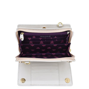 Open empty white Anuschka Organizer Wallet Crossbody - 1149 with RFID protection showing its compartments and purple lining with floral pattern.