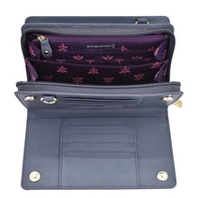 Load image into Gallery viewer, Open Anuschka navy blue genuine leather Organizer Wallet Crossbody - 1149 with RFID protection and purple interior design, displaying card slots and compartments.

