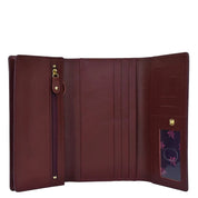Open Anuschka chic burgundy genuine leather three fold wallet showcasing multiple card slots and a zippered coin pocket.