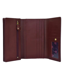 Load image into Gallery viewer, Open Anuschka chic burgundy genuine leather three fold wallet showcasing multiple card slots and a zippered coin pocket.
