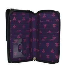 Load image into Gallery viewer, Open Anuschka purple floral-patterned genuine leather wallet with card slots and a transparent ID window.
