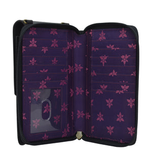 Open Anuschka purple floral-patterned genuine leather wallet with card slots and a transparent ID window.