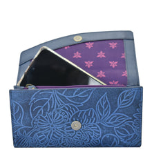 Load image into Gallery viewer, Open Anuschka Accordion Flap Wallet - 1174 with a floral pattern, containing a smartphone and showing a purple interior lining with flower print.
