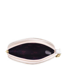 Load image into Gallery viewer, An open, empty beige genuine leather round coin purse - 1175 with a floral-patterned interior and gold-toned zipper by Anuschka.

