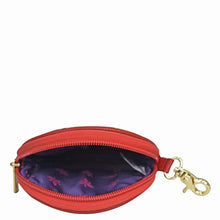 Load image into Gallery viewer, A small, open red genuine leather Round Coin Purse - 1175 with a gold zipper and a purple interior visible by Anuschka.
