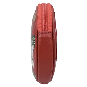 Side view of a red, genuine leather Anuschka Round Coin Purse - 1175 with a floral print design.