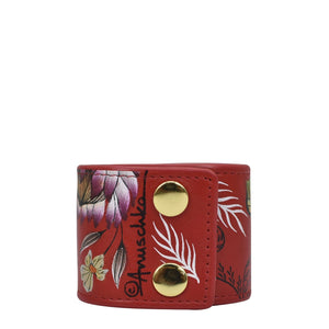 A red Anuschka genuine leather cuff bracelet with hand-painted floral design and two adjustable snap buttons.