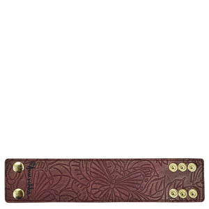 Brown floral embossed Anuschka Leather Adjustable Wrist Band with snap fasteners.
