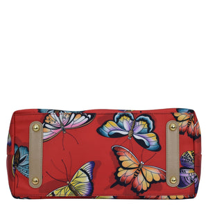 Colorful butterfly-patterned Fabric with Leather Trim Zip Top City Tote - 12005 by Anuschka on a white background.