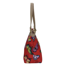 Load image into Gallery viewer, An Anuschka Fabric with Leather Trim Zip Top City Tote - 12005 with a butterfly print design and a leather shoulder strap.
